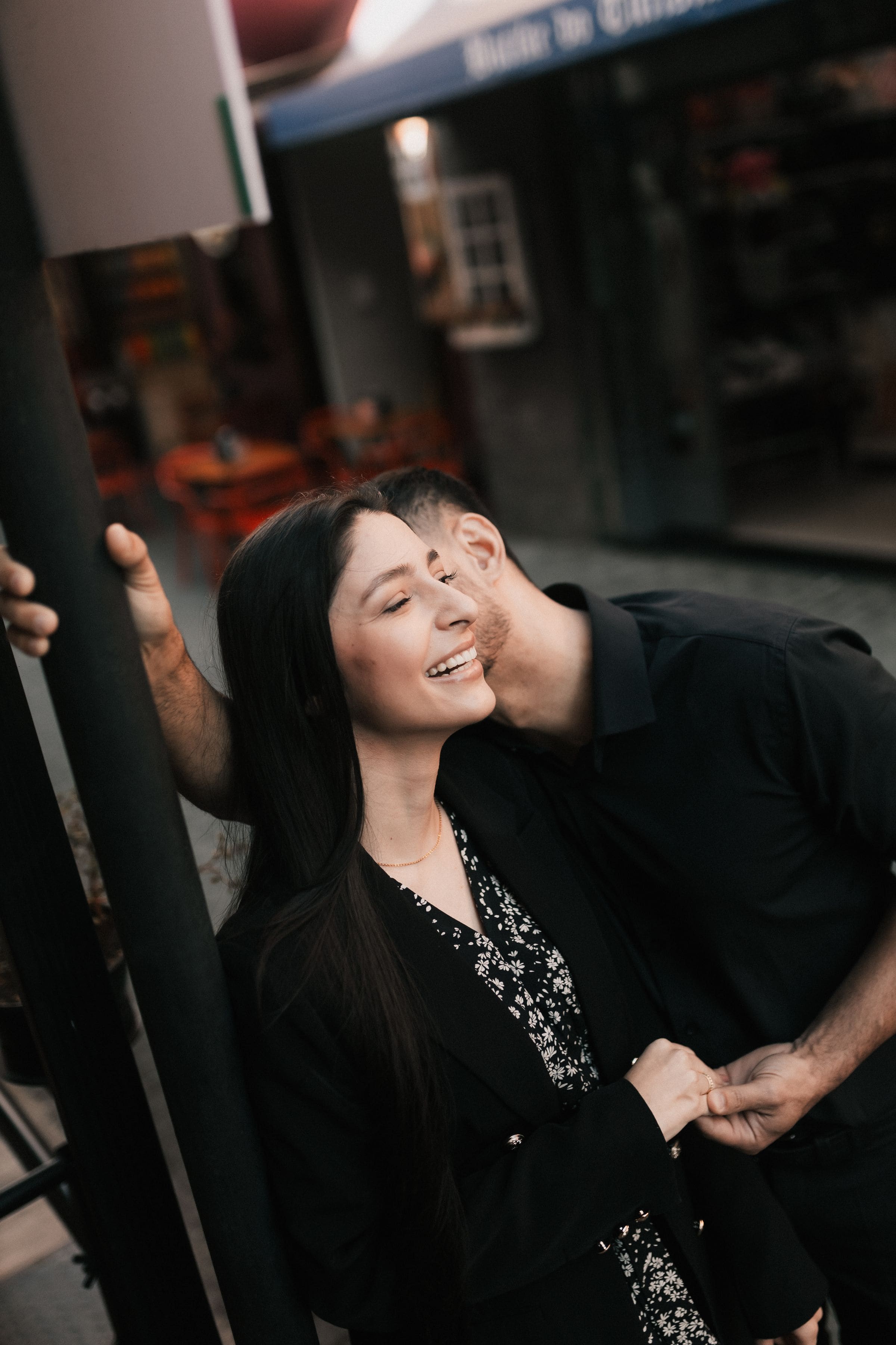 Couple laughing together on a city street at sunset