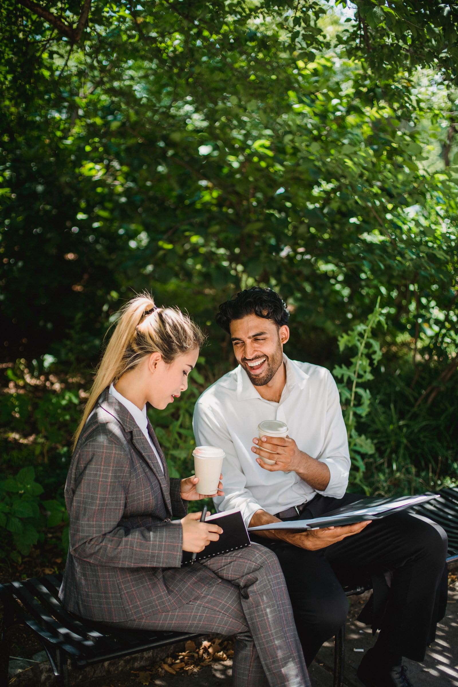 Man and woman talking over coffee outdoors