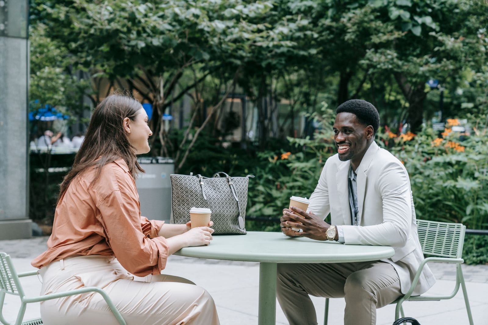Two people talking at an outdoor café