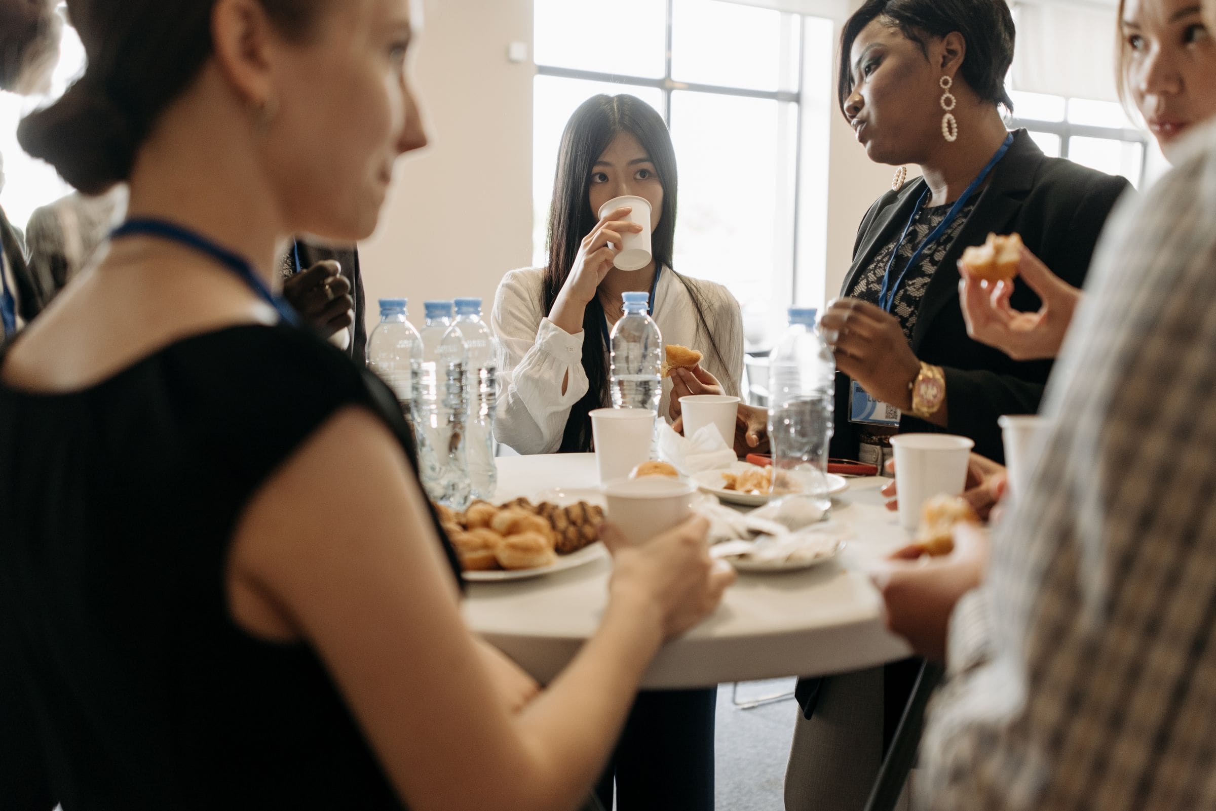 Professionals talking over coffee at a networking event