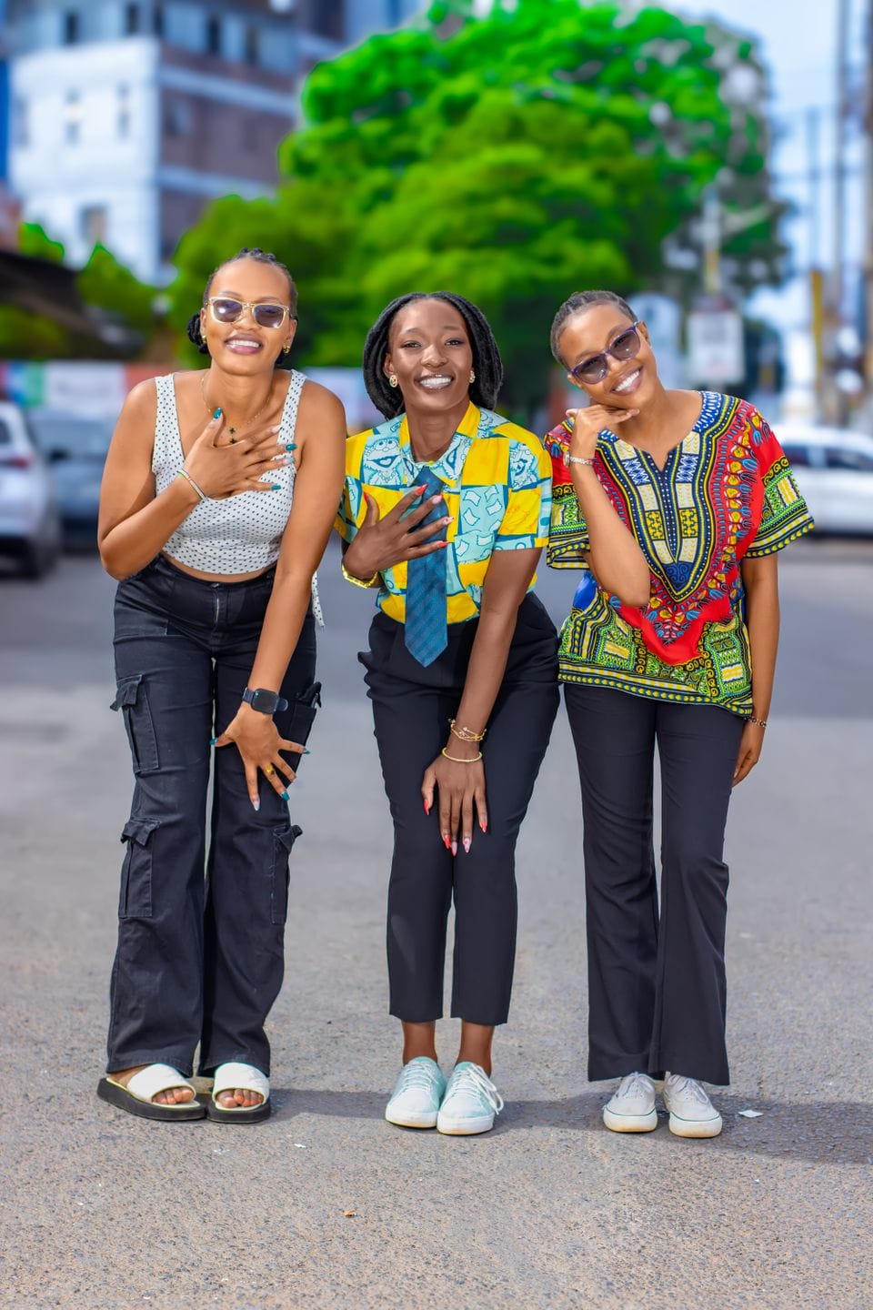 Three friends together on a city street