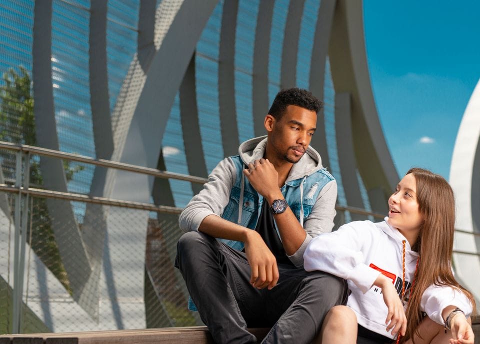 Two people talking together in the city