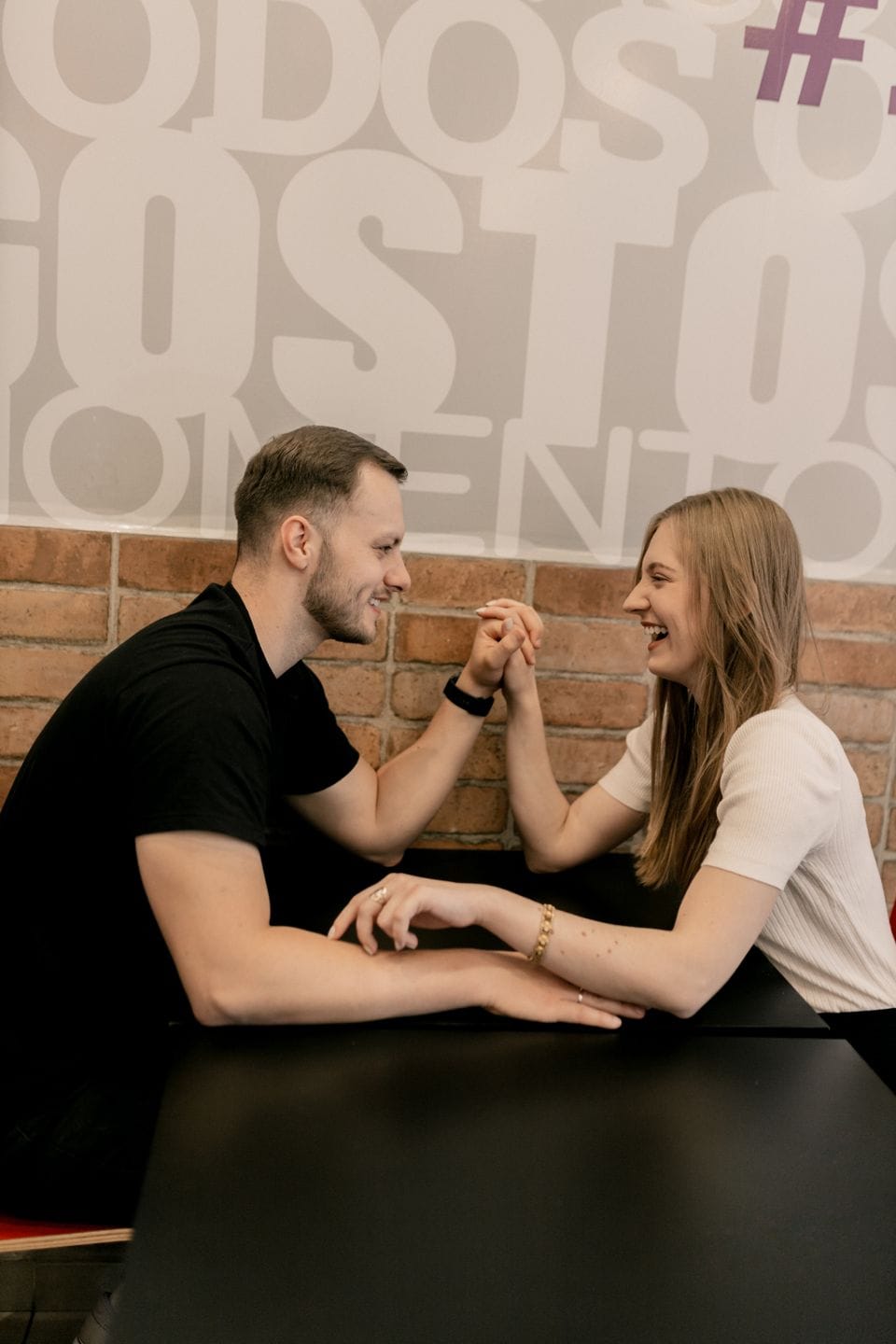 Two people smiling across a café table