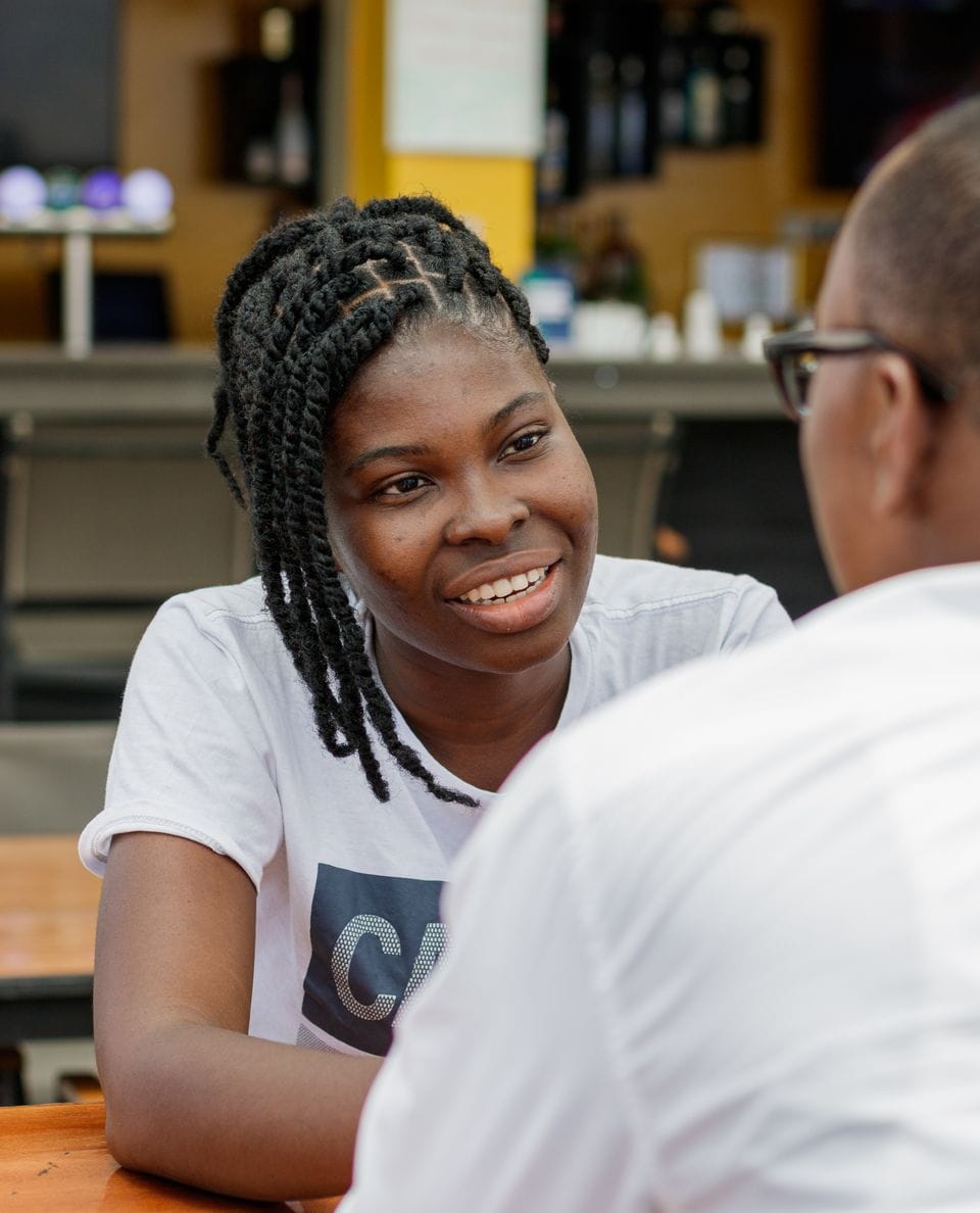 Two people talking at an outdoor café