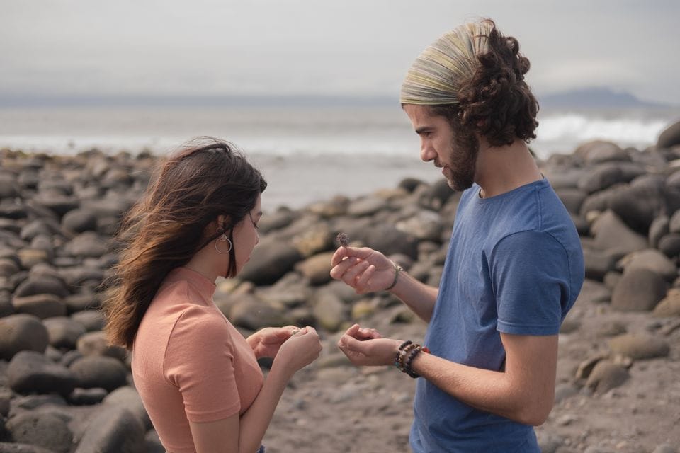 Two people exploring a rocky shoreline