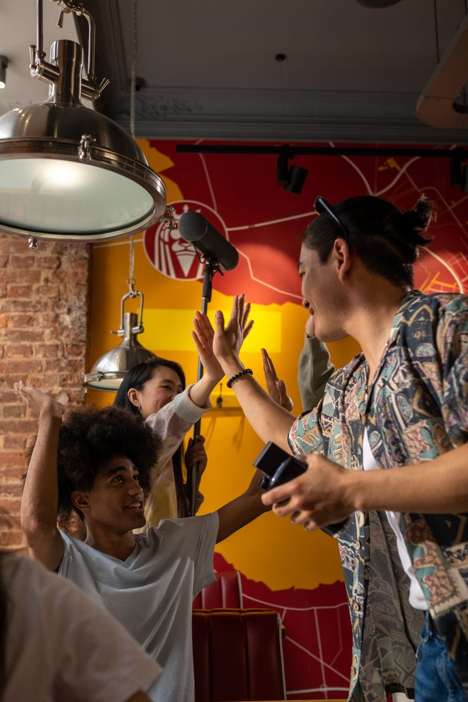 Friends exchanging high fives at a café
